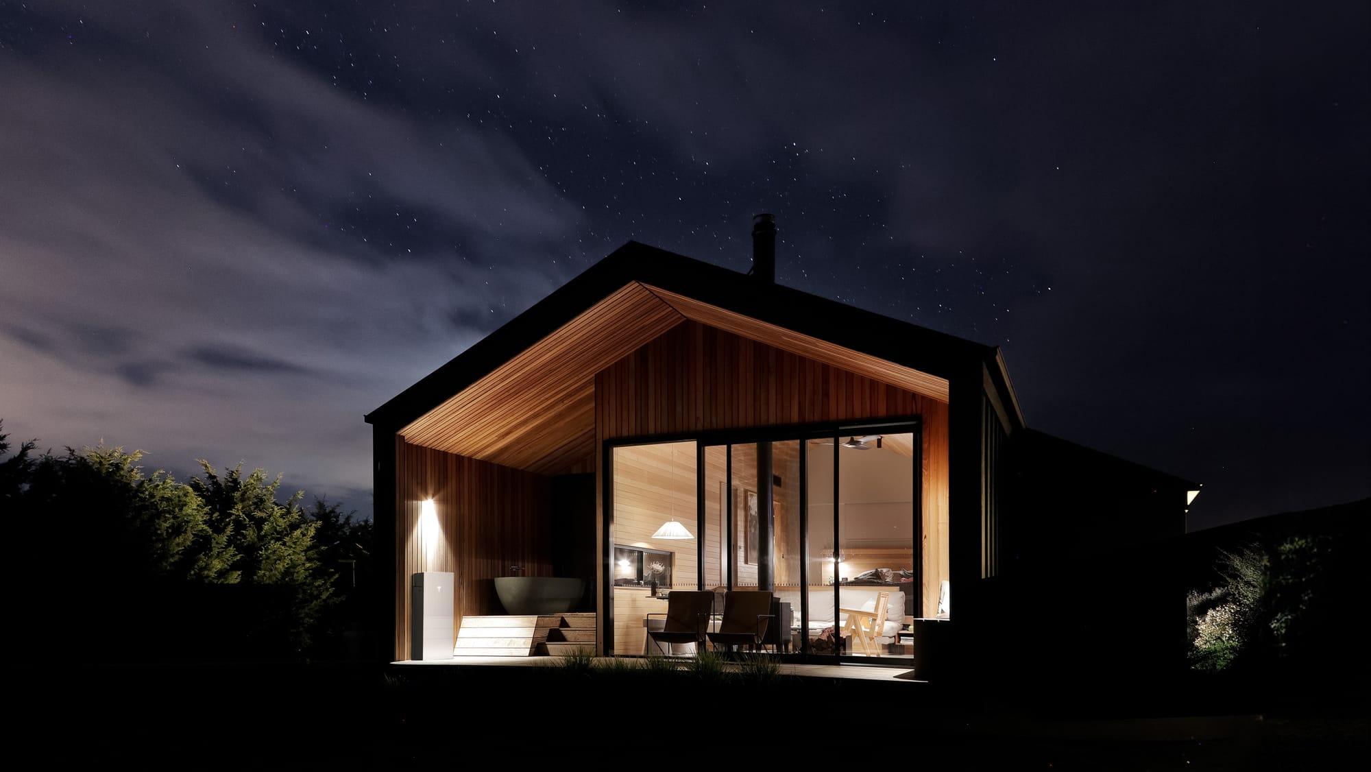 Tesla Powerwall home battery backup system mounted outside a home during peak pricing or an outage.