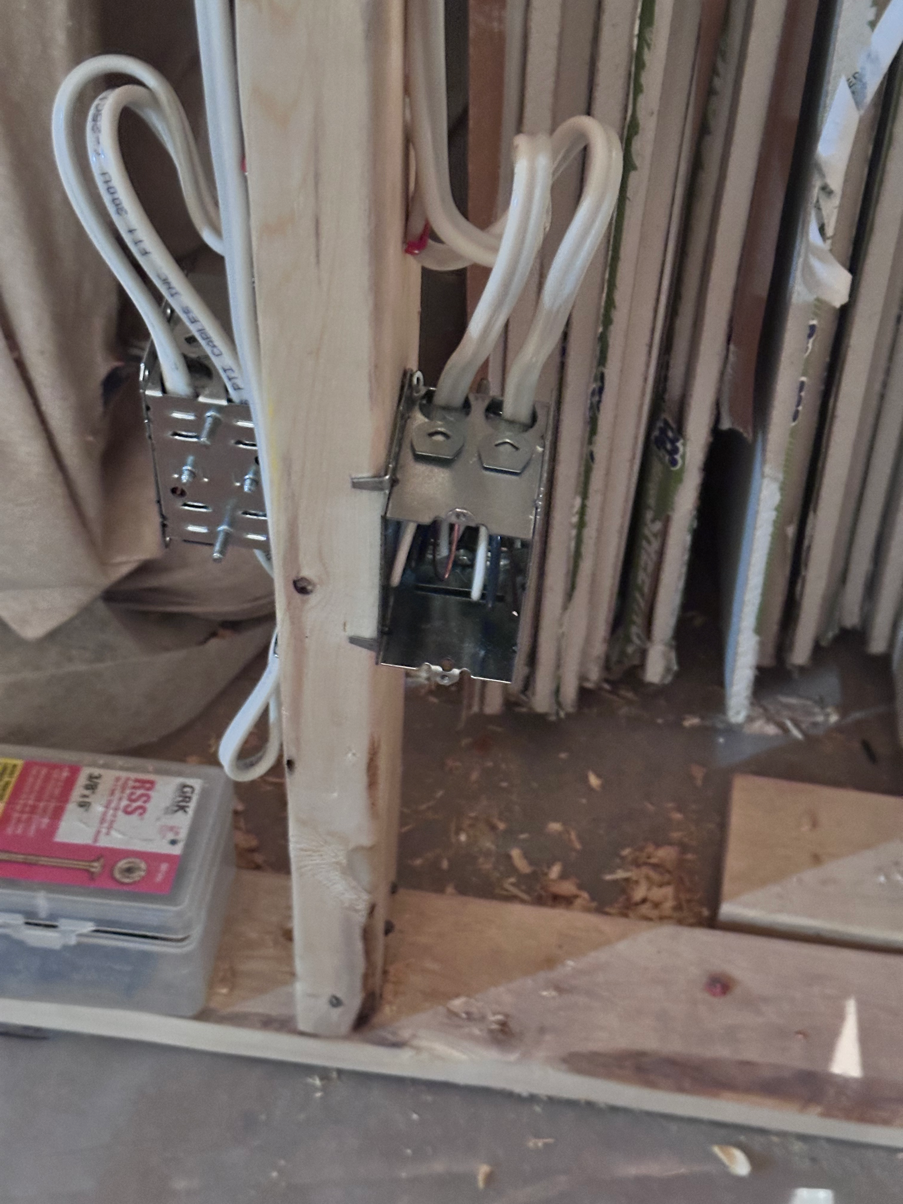 Electrical device boxes with neatly routed cables during rough-in on a residential renovation.
